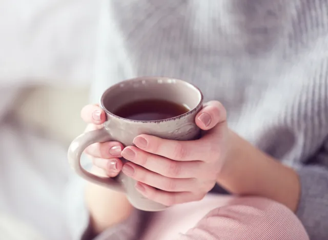 woman holding cup of tea