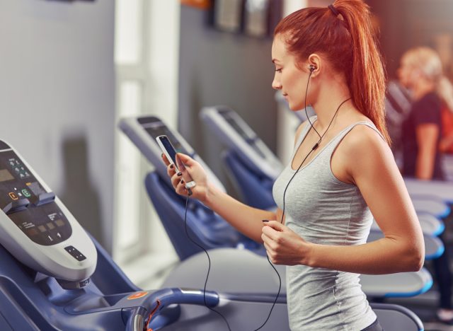 woman listening to music on treadmill