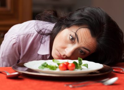 woman looking at salad