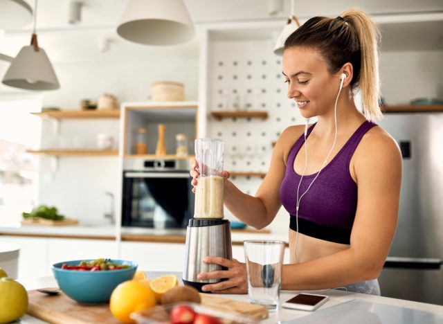 woman making fruit smoothie