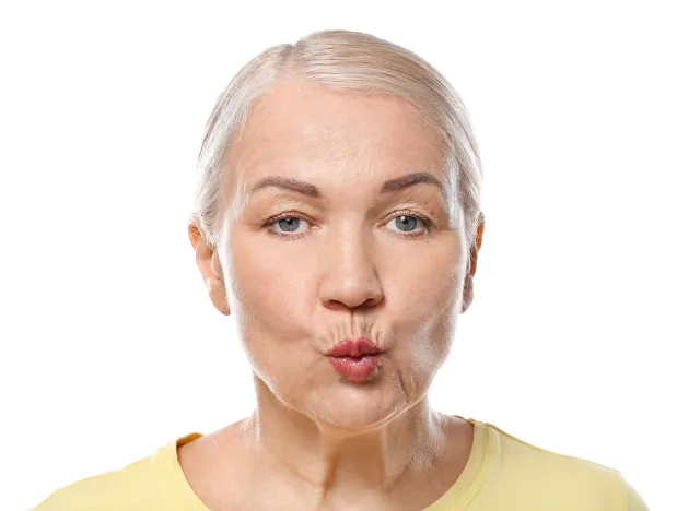 older woman close-up face jowl exercises