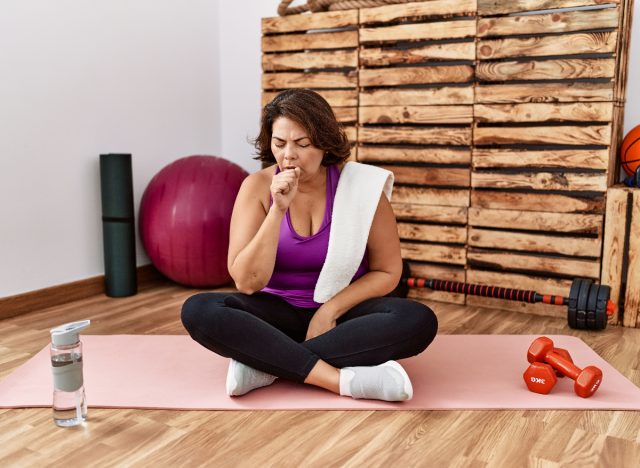 woman coughing in fitness class, biggest gym pet peeves