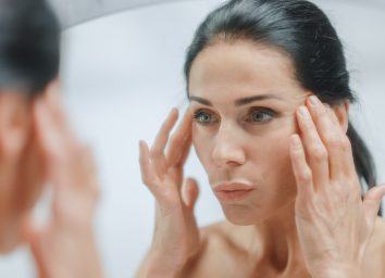 woman in bathroom depicting how to address wrinkles in your 40s