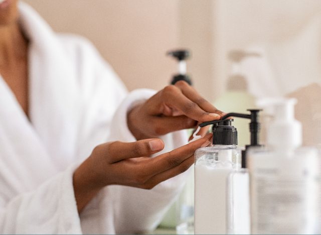 close-up woman using skincare products