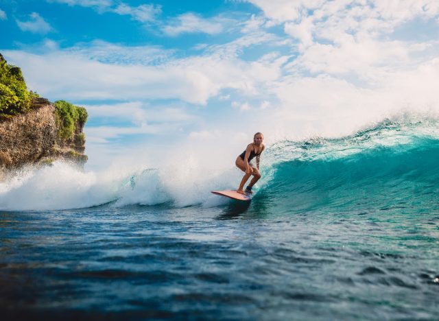 woman surfing, workouts that don't feel like work