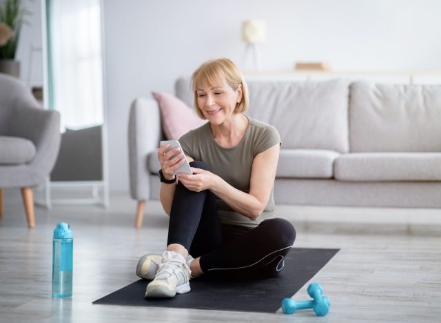 A happy woman who keeps track of fitness progress and loses her belly quickly