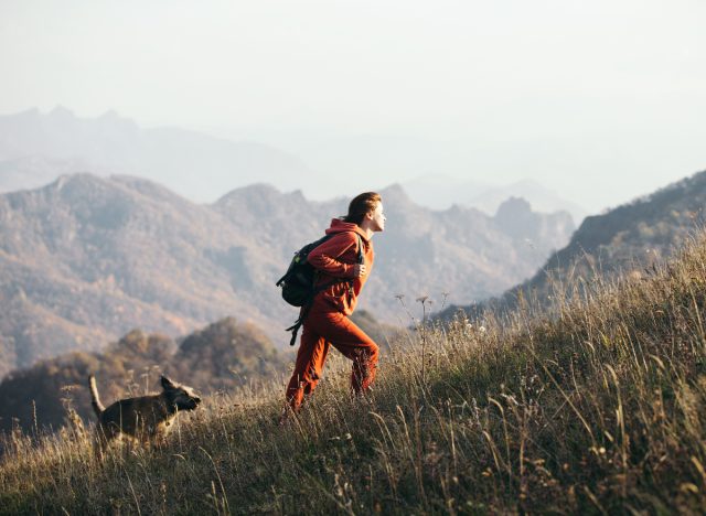 woman doing uphill hike, exercise to lose inches off your waist