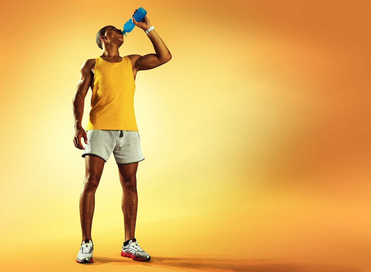 Man Working Out And Drinking Out of Bottle
