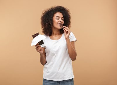 Woman eating chocolate bar