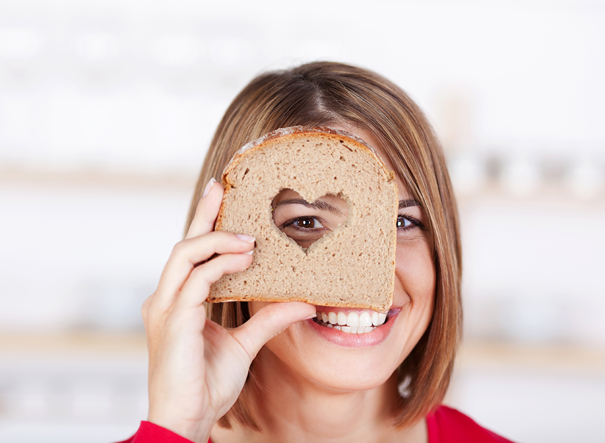 Woman holding bread with heart