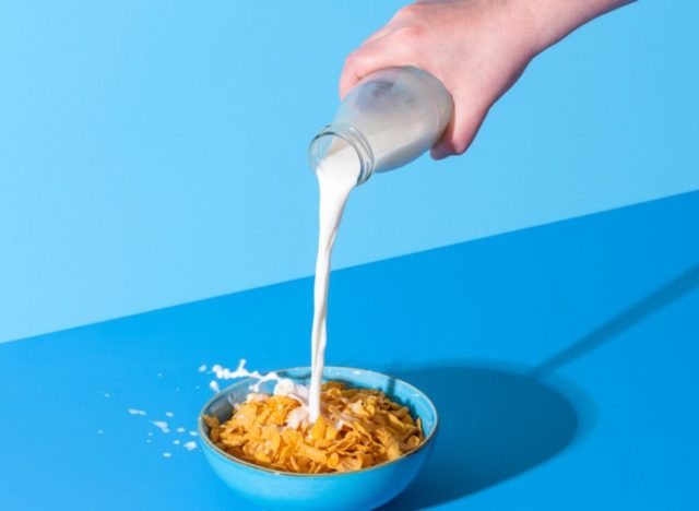 bowl of cereal with milk pouring into it