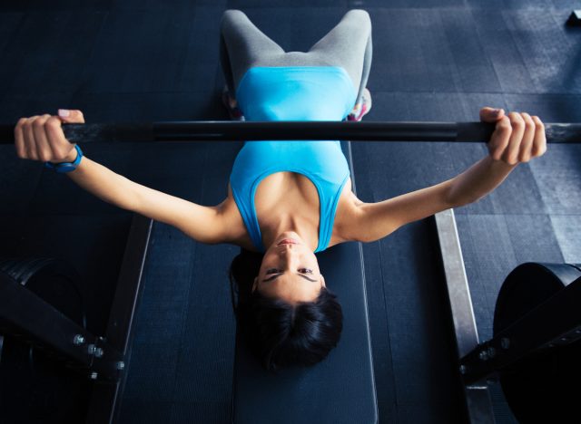 woman barbell bench chest press, demonstrating exercise to get your best body ever