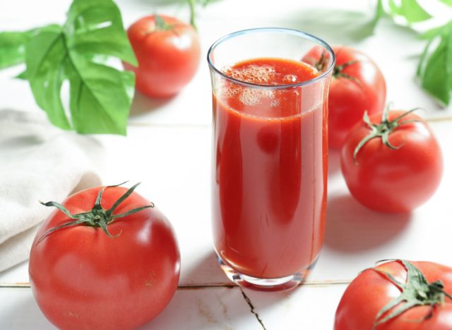 glass of fresh tomato juice and tomatoes
