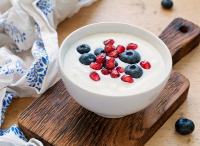 greek yogurt with blueberries and pomegranate seeds