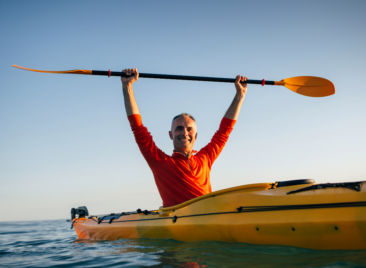 happy man kayaking, demonstrating staying young and adding years to your life
