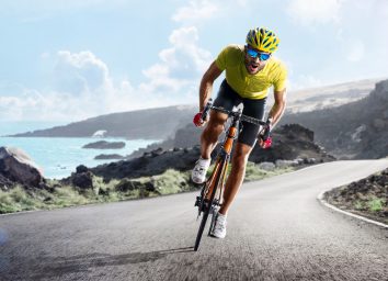 intense cyclist climbing uphill to lose belly fat in a week