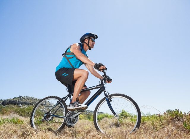 man bike riding through countryside to manage low blood sugar