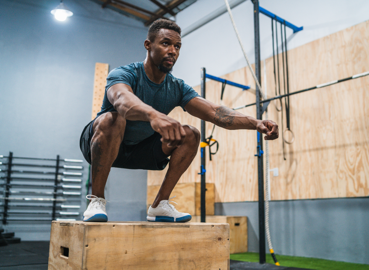 man doing box jump to lose pot belly fat