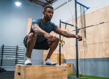 man doing box jump to lose pot belly fat