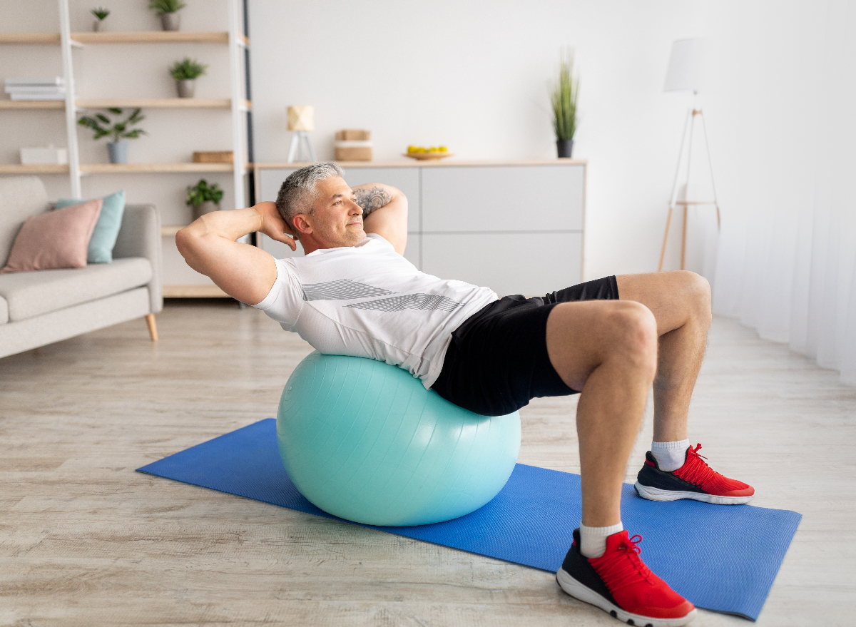 mature man doing stability ball exercises to reverse aging after 50