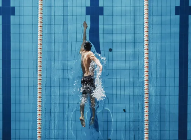 man swimming to manage low blood sugar