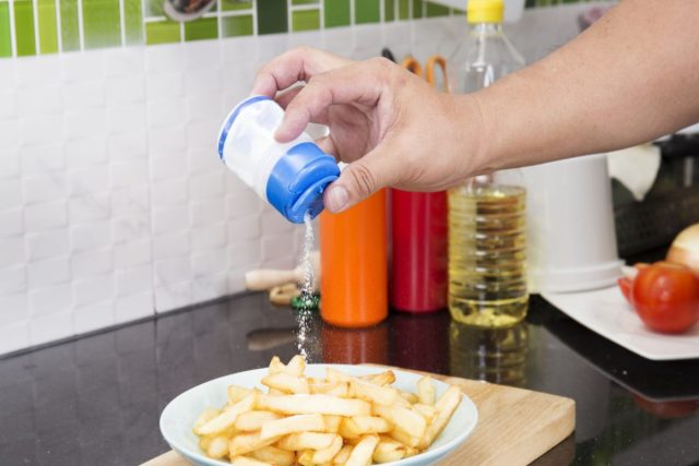 pouring salt on french fries