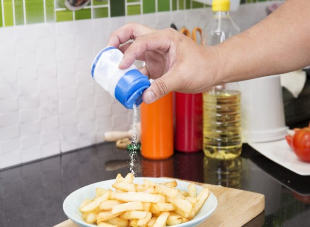 pouring salt on french fries