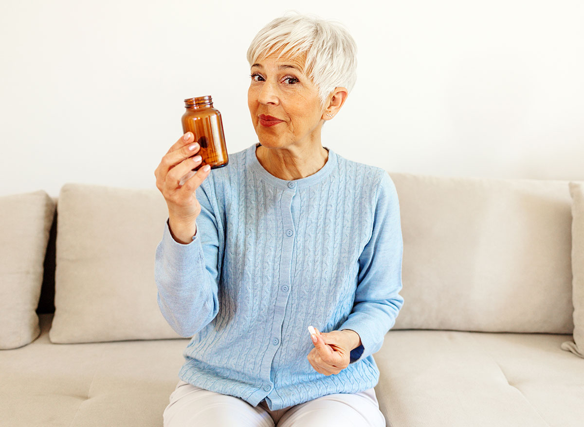 Portrait,Of,Senior,Woman,At,Home,Holding,Medicines,Supplement
