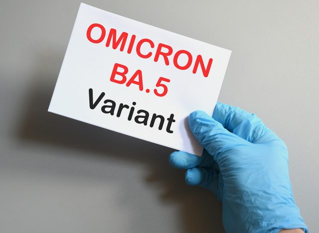 Covid-19 new Omicron variants. Hand of the doctor in blue glove hold a white paper with text "Omicron BA.5 Variant". Concept for the new Covid 19 Omicron variants