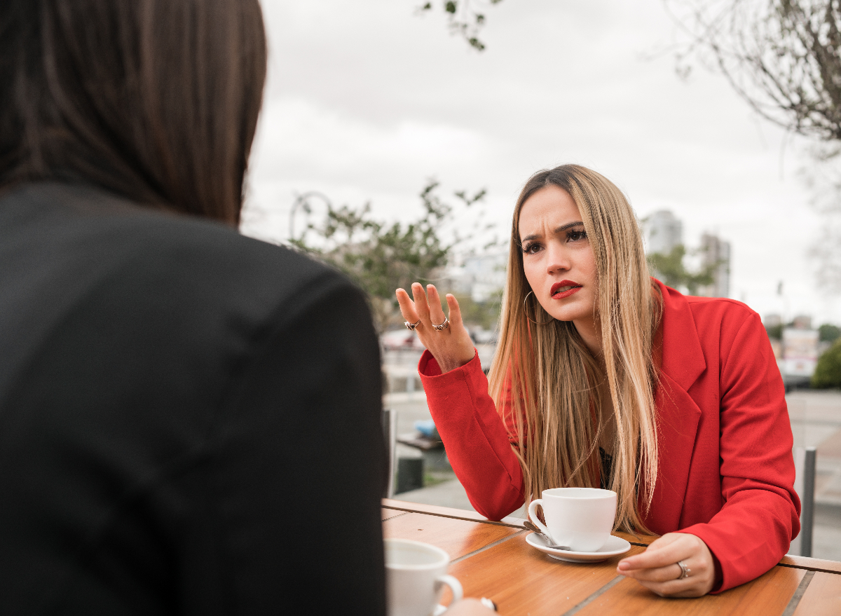 unhappy woman having coffee outside expressing her feelings after being betrayed by a best friend
