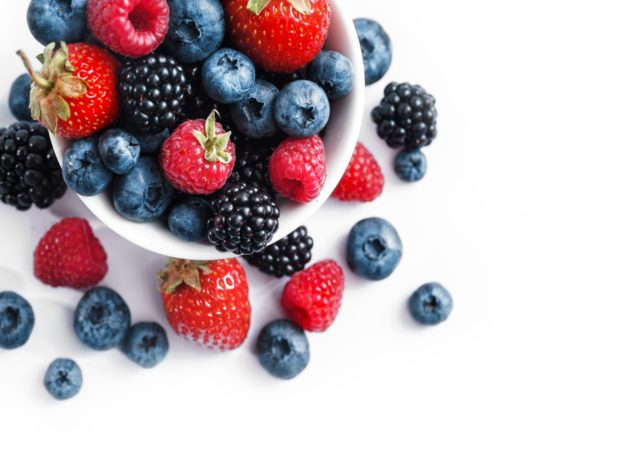 white bowl with strawberries, blueberries, raspberries, and blackberries