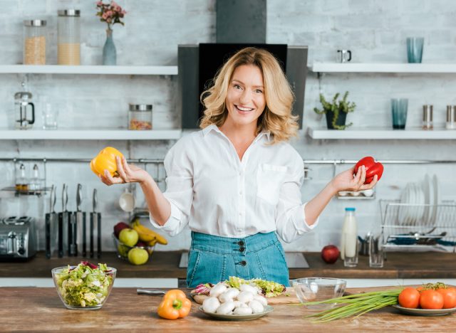 woman cooking with bell peppers to lead an incredibly healthy lifestyle