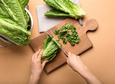 woman cutting romaine lettuce