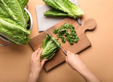 woman cutting romaine lettuce