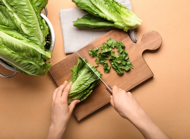 woman cutting romaine lettuce