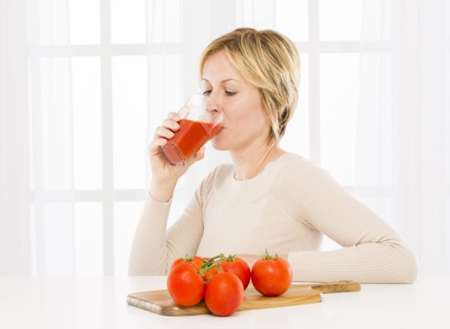 woman drinking tomato juice