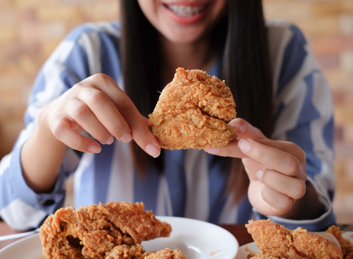 woman eating fried chicken