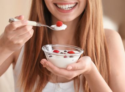 woman eating yogurt with berries