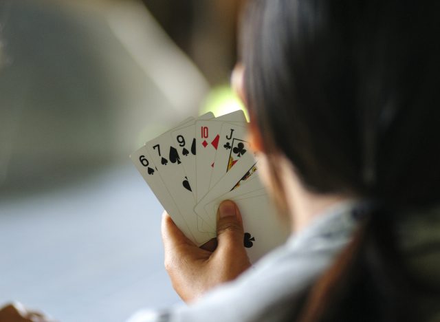 woman with a hand full of cards