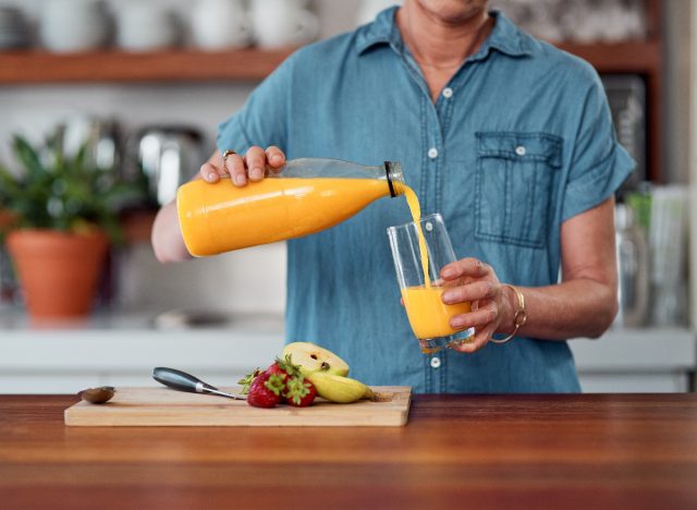 woman pouring orange juice
