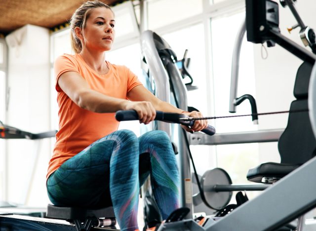 woman using rowing machine