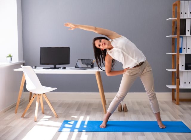woman stretching doing an in-office workout