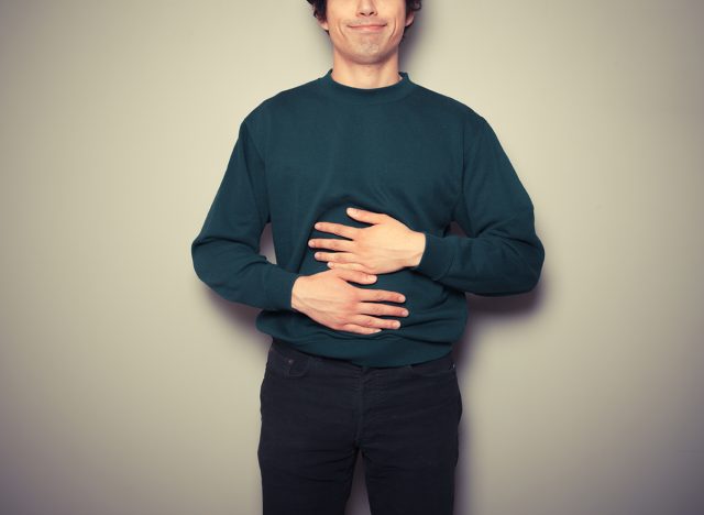 Man feeling hungry, holding stomach