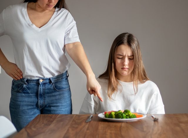 Parent forcing kid to eat vegetables