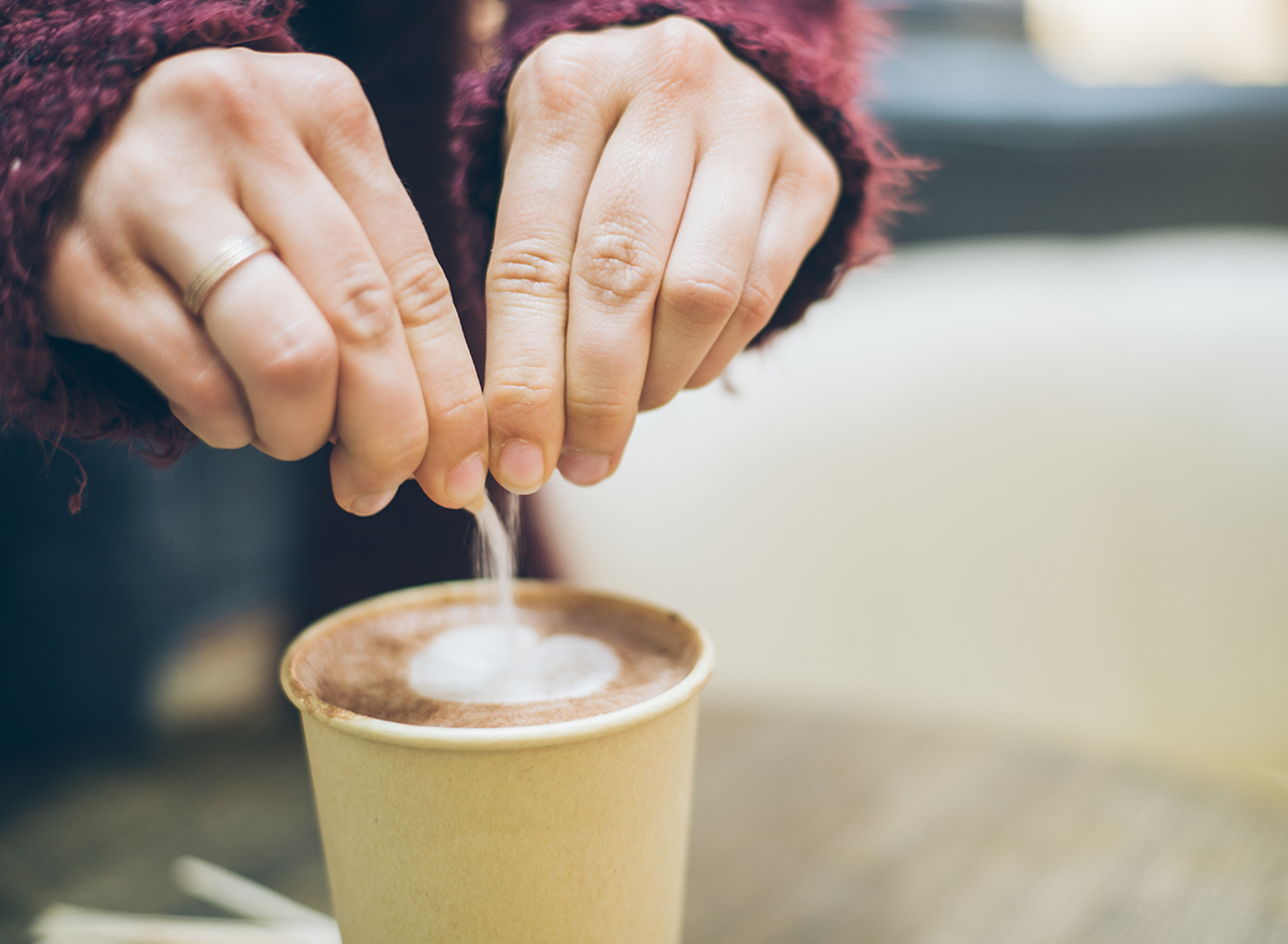 Pouring sugar into coffee