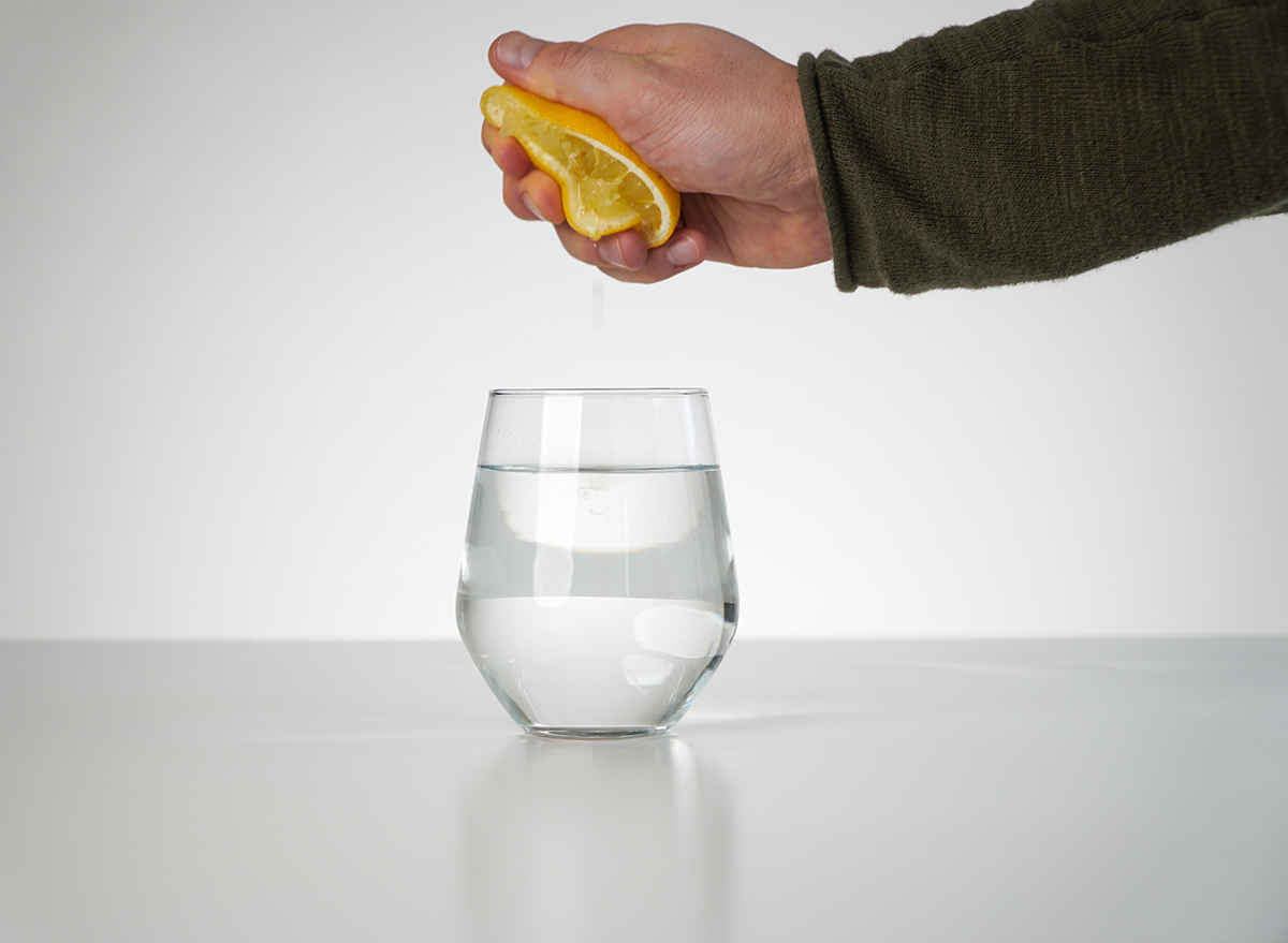 Squeezing lemon into water