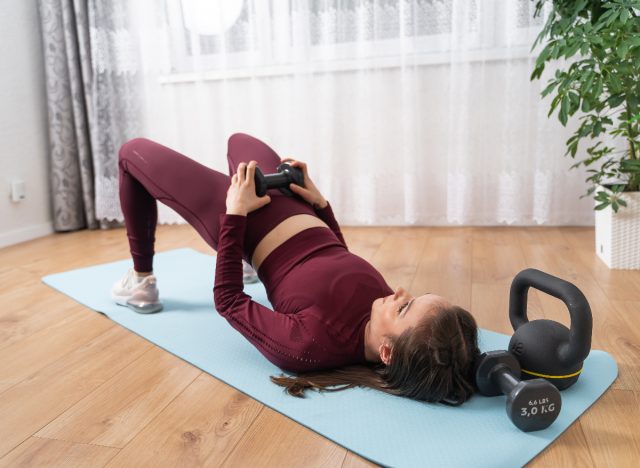 woman performing dumbbell glute bridge