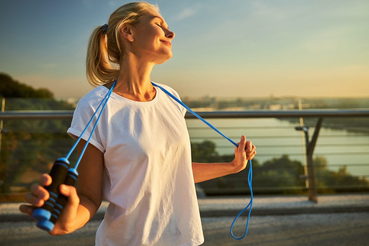 happy mature woman holding jump rope demonstrating how to lead an incredibly healthy lifestyle