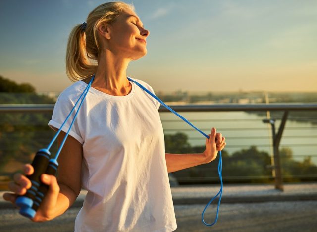 happy mature woman holding jump rope demonstrating how to lead an incredibly healthy lifestyle