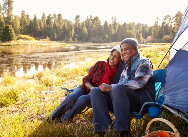 happy senior couple fall camping trip, experiencing the camping habits that slow aging